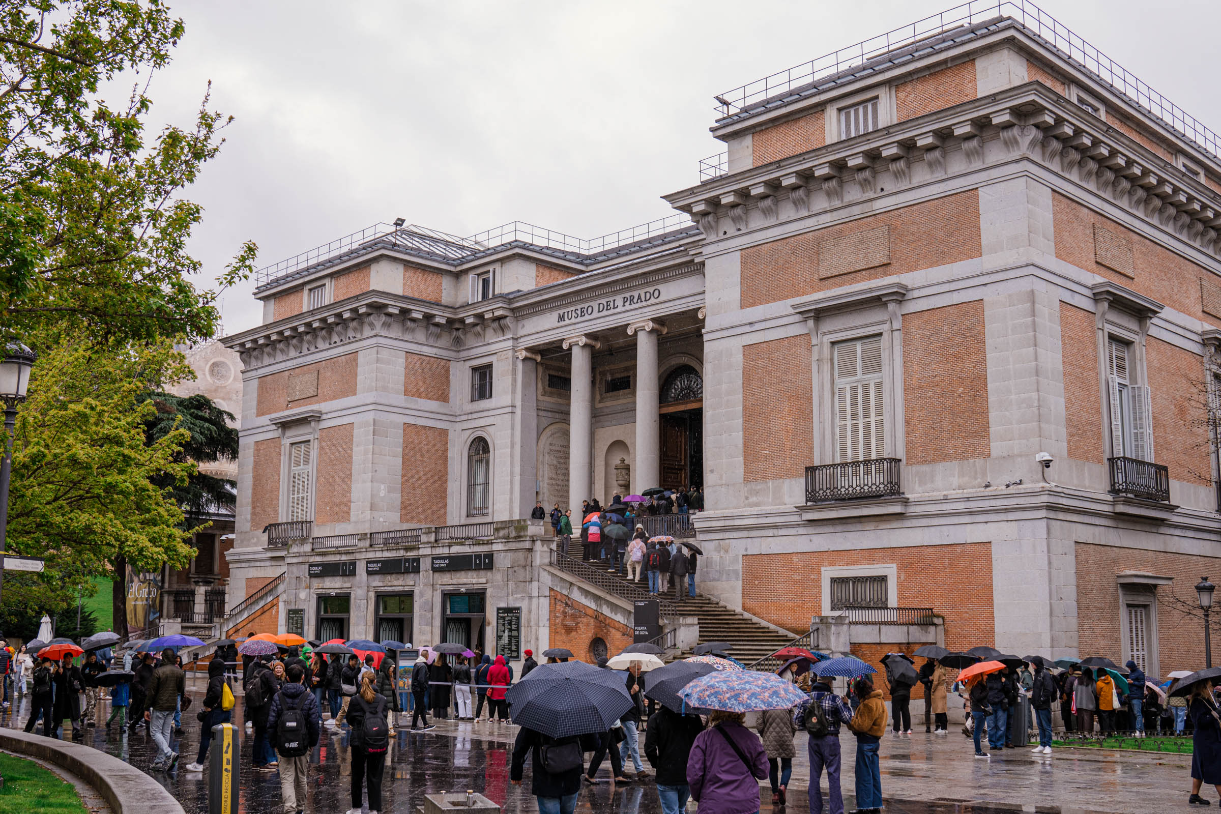 The Prado Museum from the outside - the classic facade and the queue of visitors in front of the entrance (Madrid, Spain)