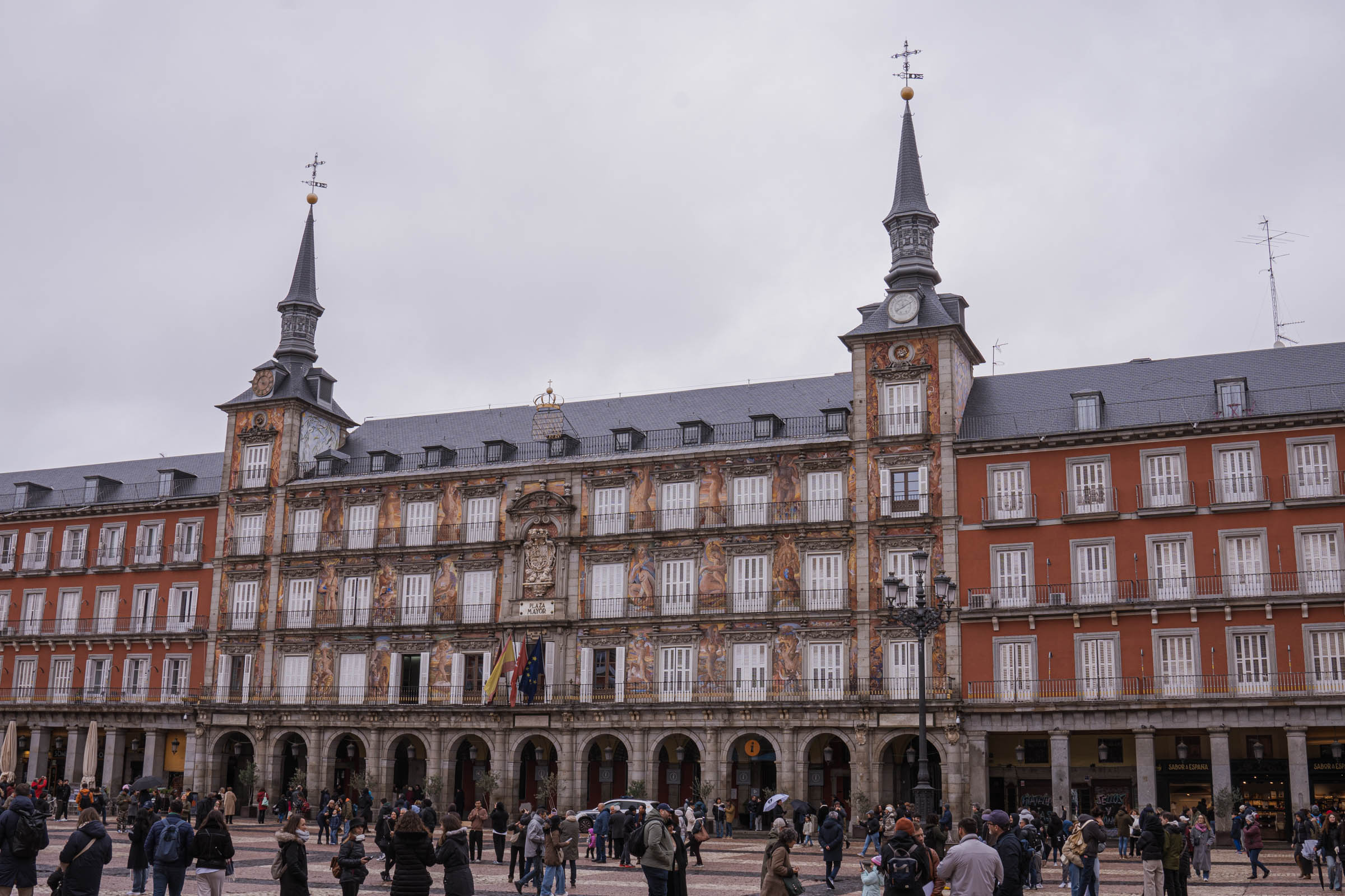 Wide view of Plaza Mayor, Madrid's historic square surrounded by traditional facades and arcades