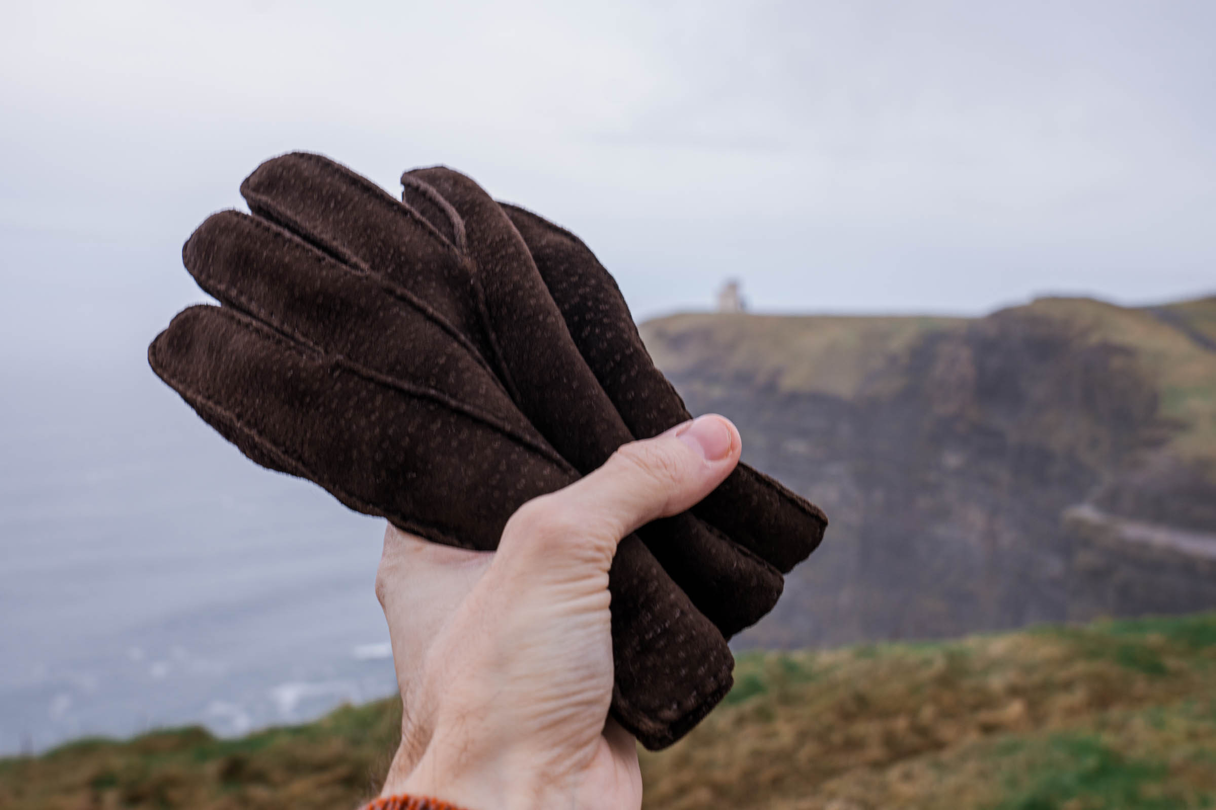 Restelli Guanti peccary leather gloves complete the luxurious outfit on the Irish cliffs.