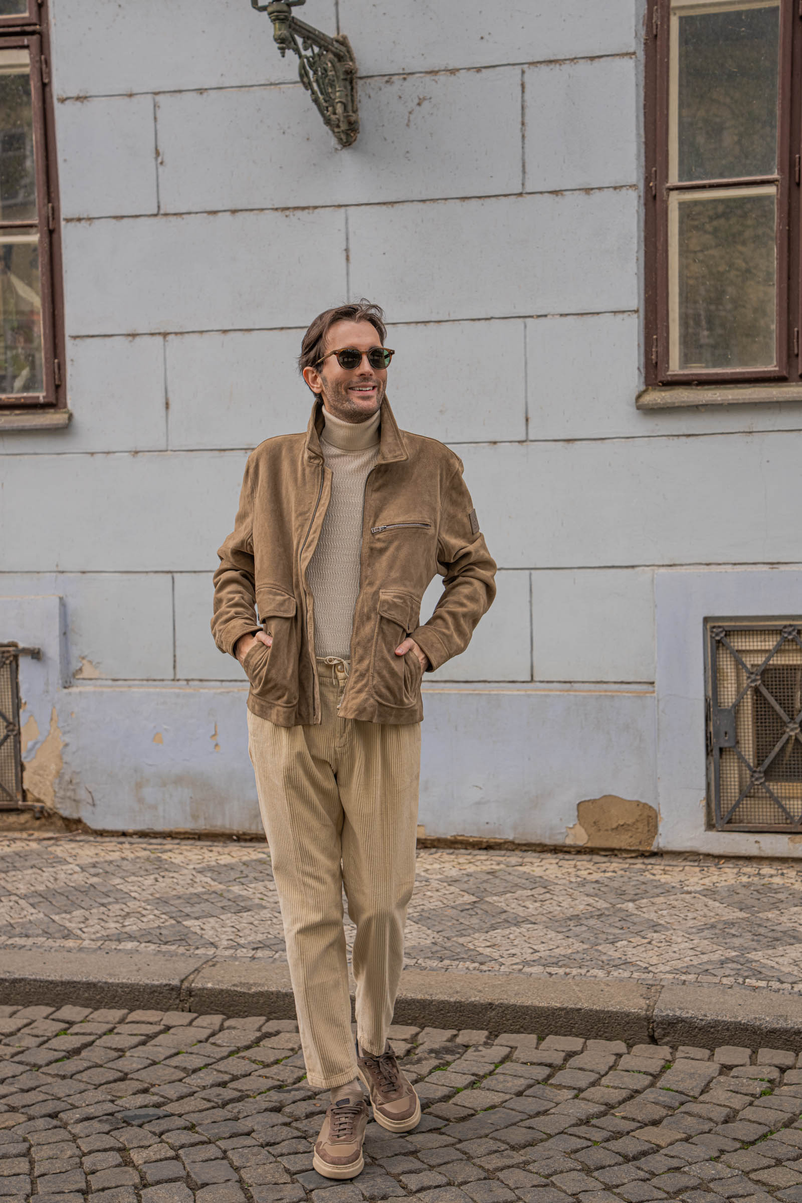 Marko Tadić, founder of Mr.M by Marko Tadić blog, walking past the Archibald at the Charles Bridge hotel on Kampa island in a Belstaff and Loro Piana spring outfit.