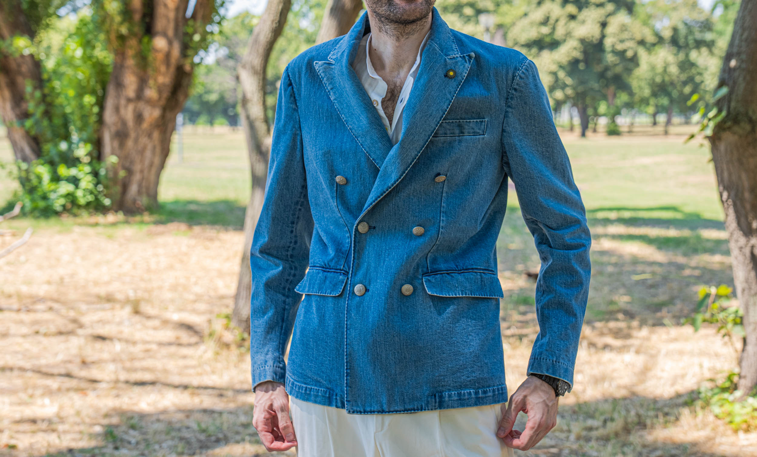 Front view of the Giannetto Portofino double-breasted denim jacket in a medium indigo wash, styled by Marko Tadić with cream high-waisted trousers