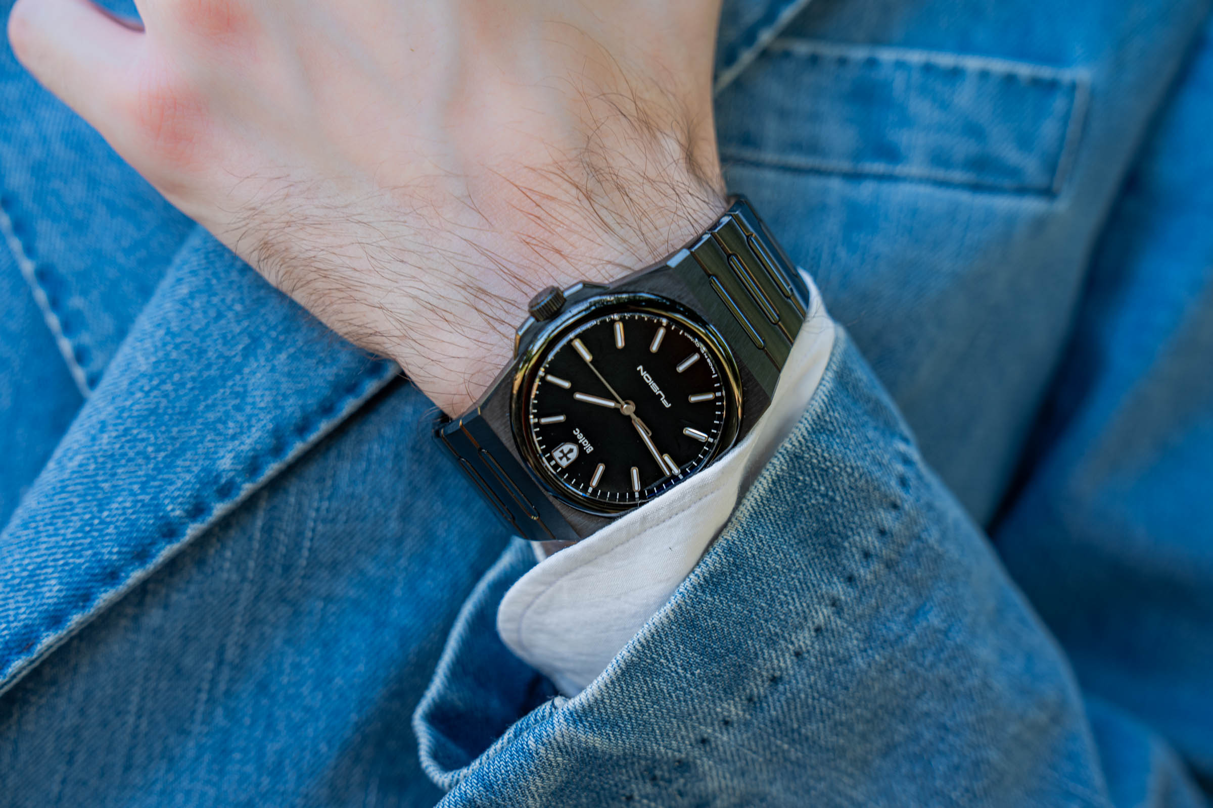 Black DLC Biatec Fusion 03 automatic watch on Marko Tadić's wrist, framed by a white shirt cuff and a light blue denim jacket sleeve