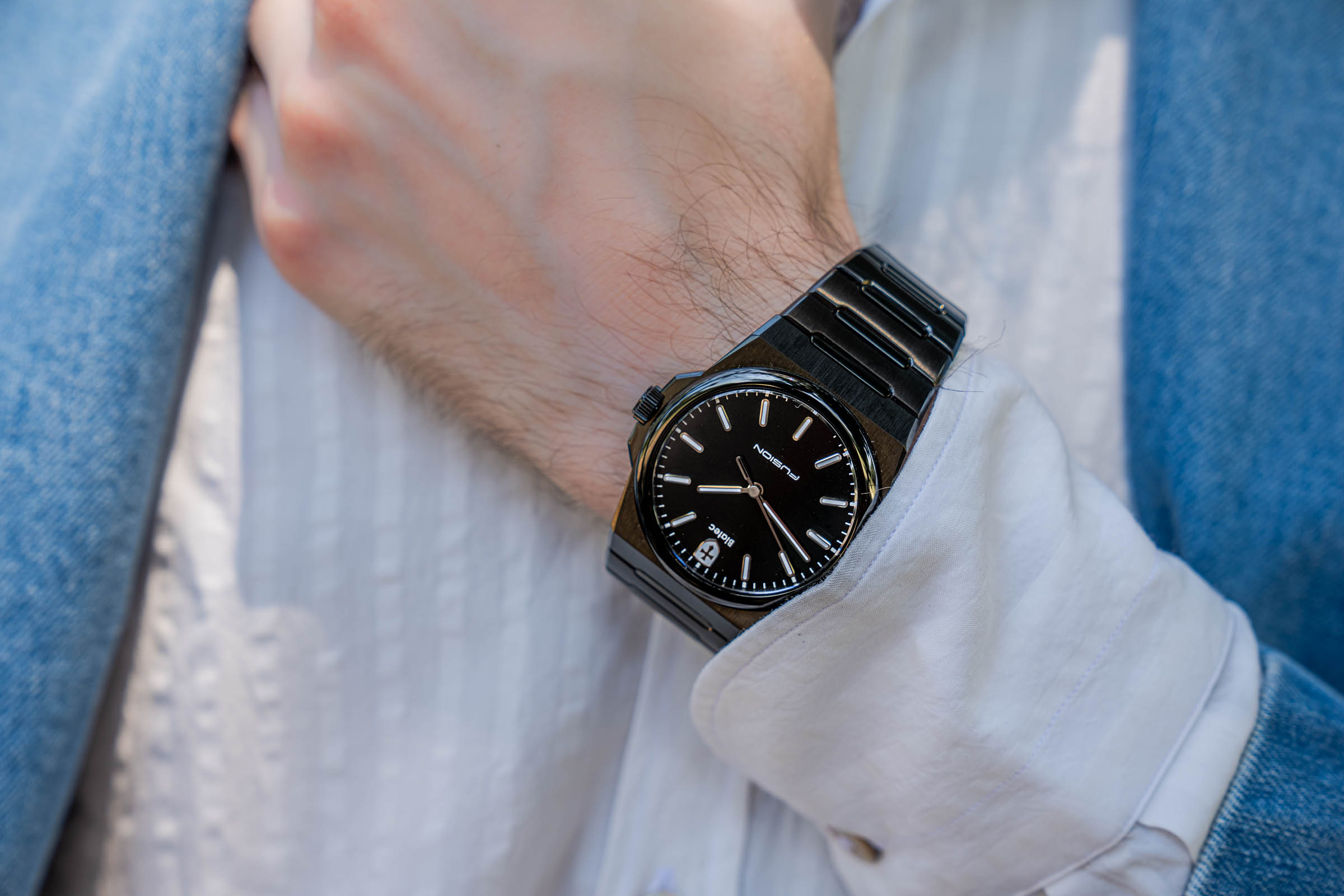 The 39 mm Biatec Fusion 03 in black DLC steel slipping under Marko Tadić's white shirt cuff, its slim 9 mm case ideal for summer tailoring