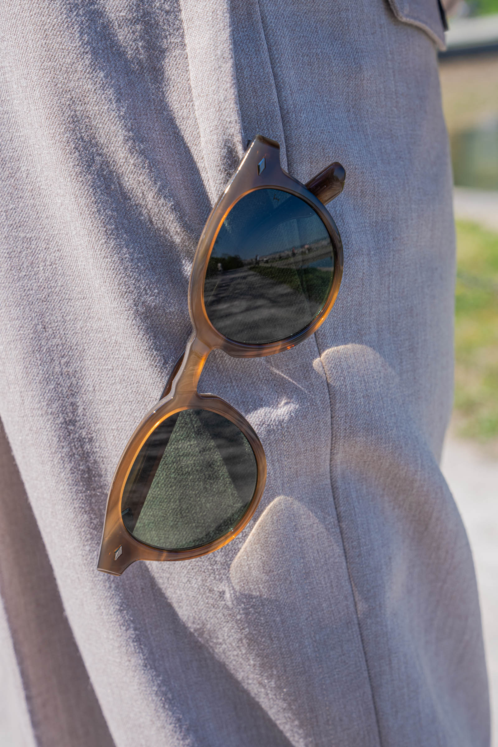 FAÇONNABLE round sunglasses in light horn hanging from the pocket of Giorgio Armani beige trousers worn by Marko Tadić of the Mr.M blog