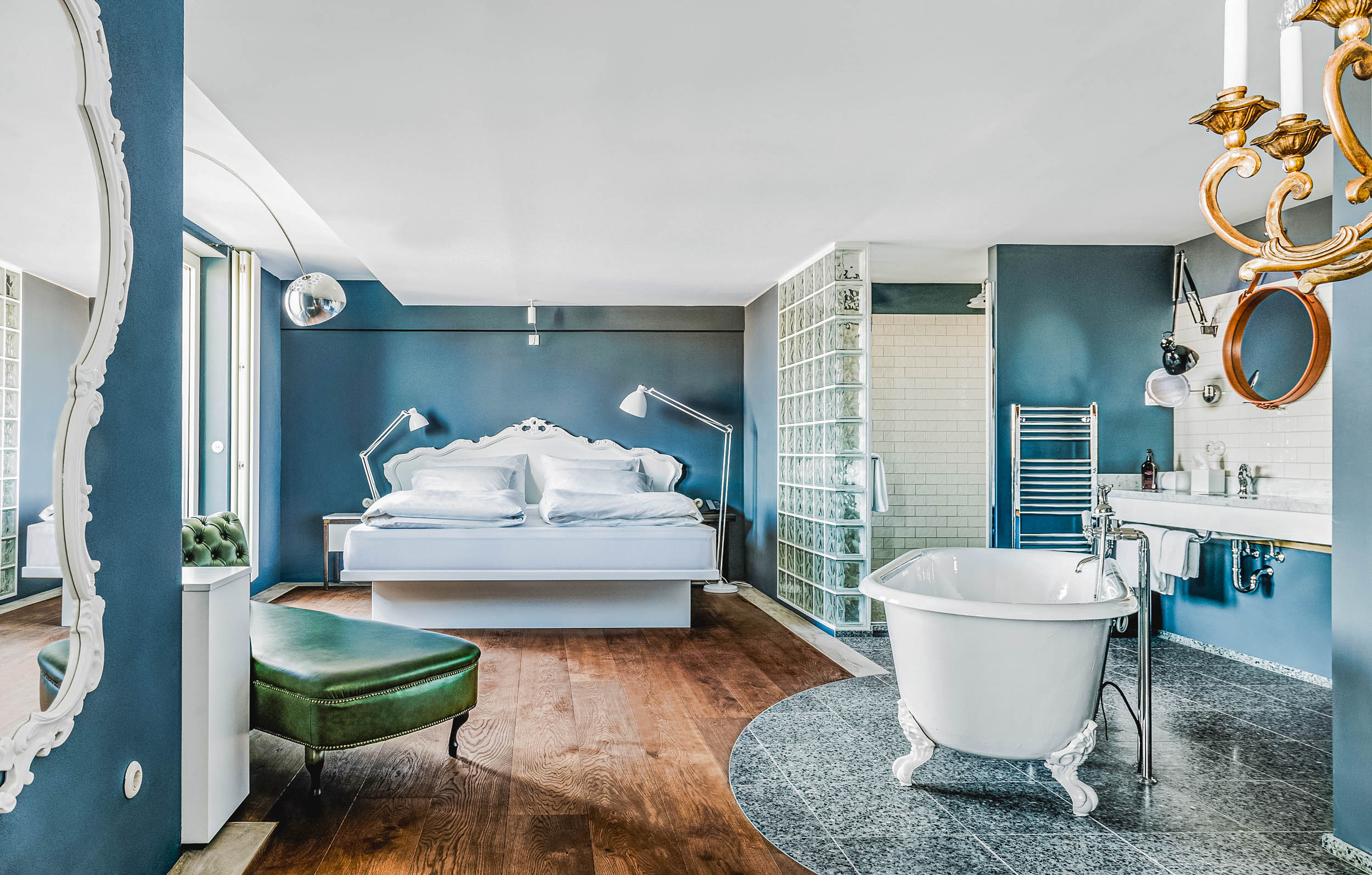 Grand Ferdinand Hotel Vienna suite with freestanding bathtub, baroque white bed and elegant blue-grey walls