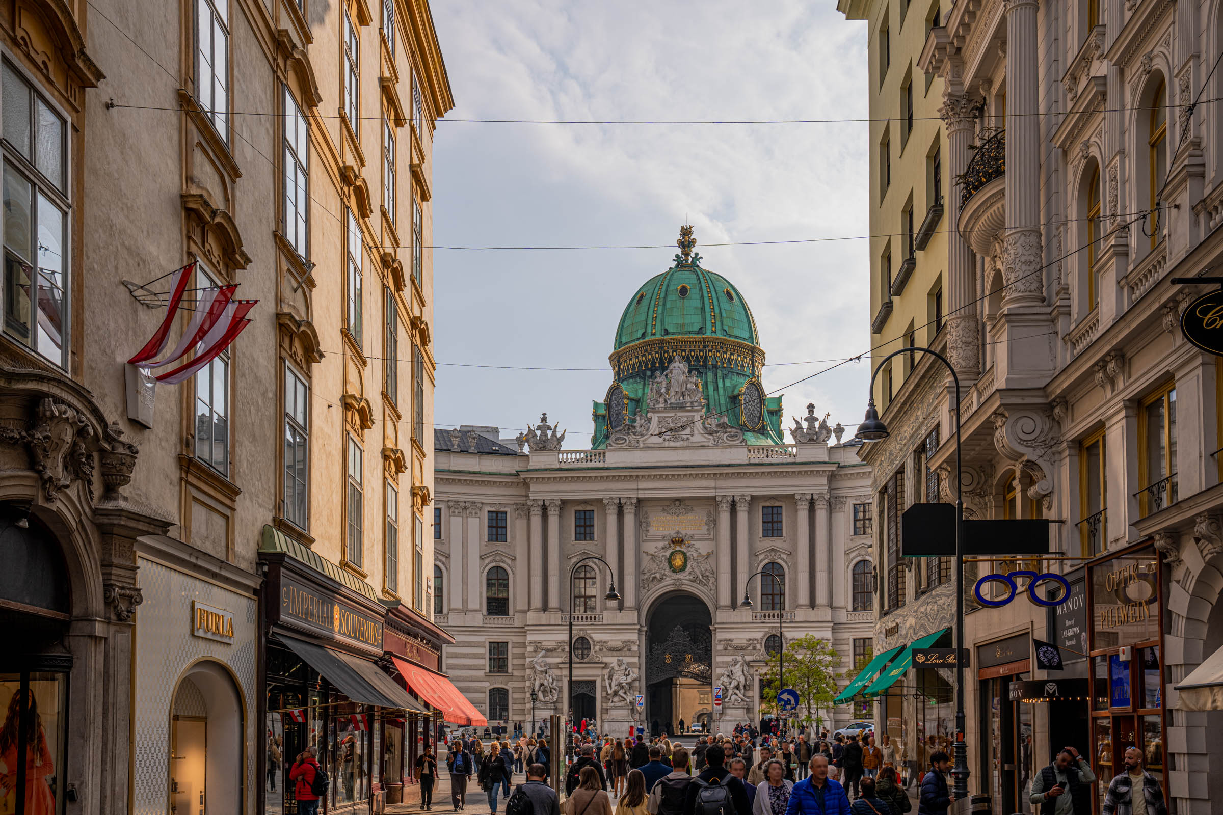 View along Kohlmarkt street toward the green dome of Hofburg Palace, one of Vienna's most photographed scenes