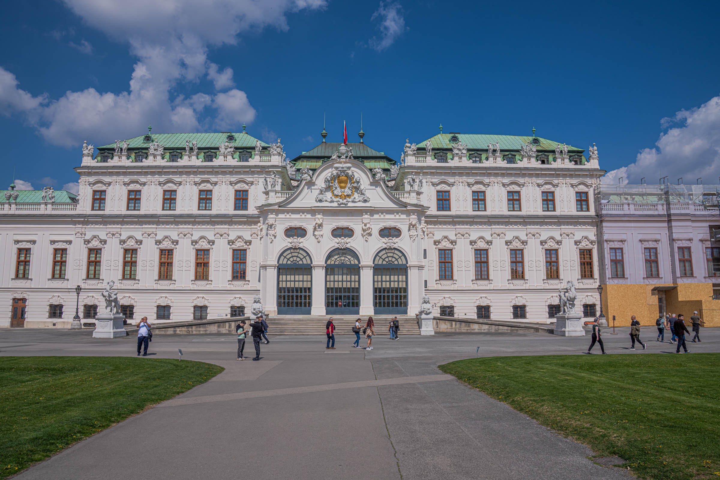 Upper Belvedere Palace Vienna with green copper roofs and formal gardens filled with visitors in spring