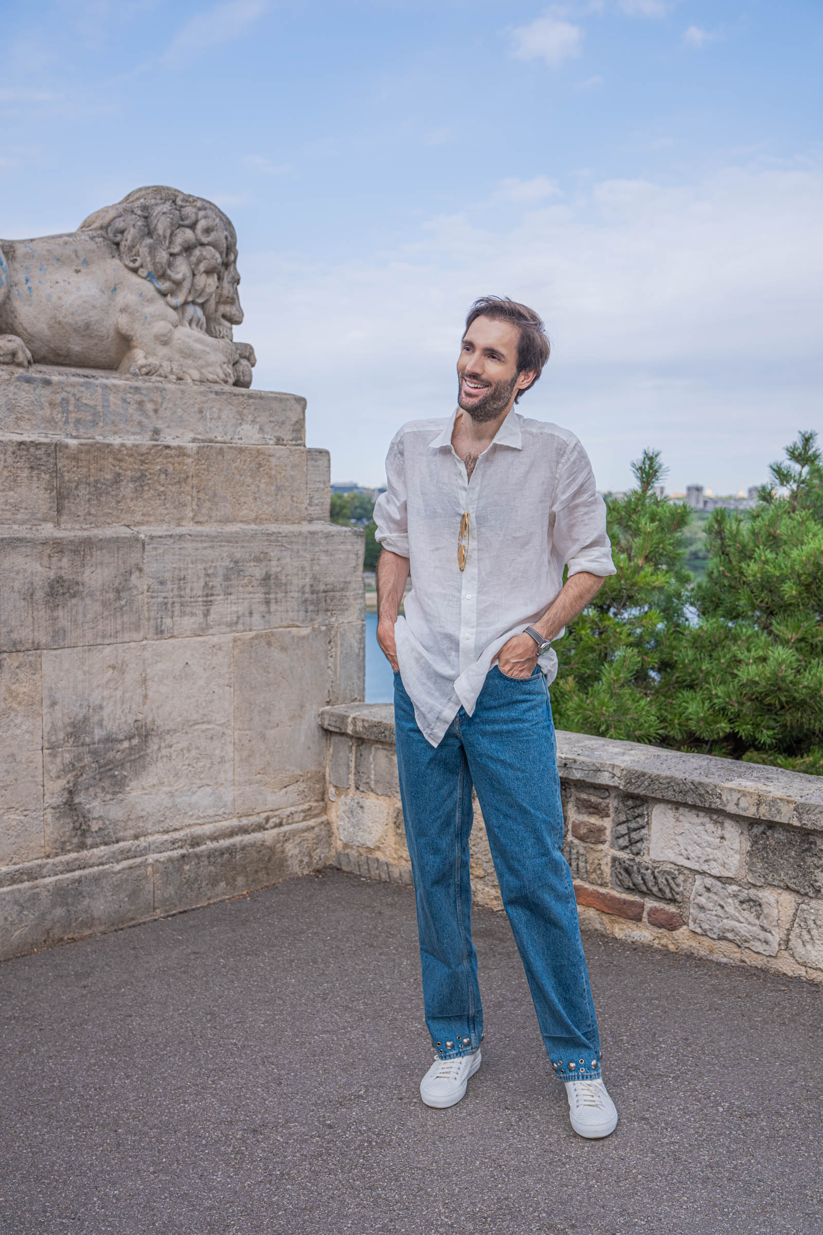 Marko Tadić in an oversized Valentino white linen shirt with the Sava river behind him