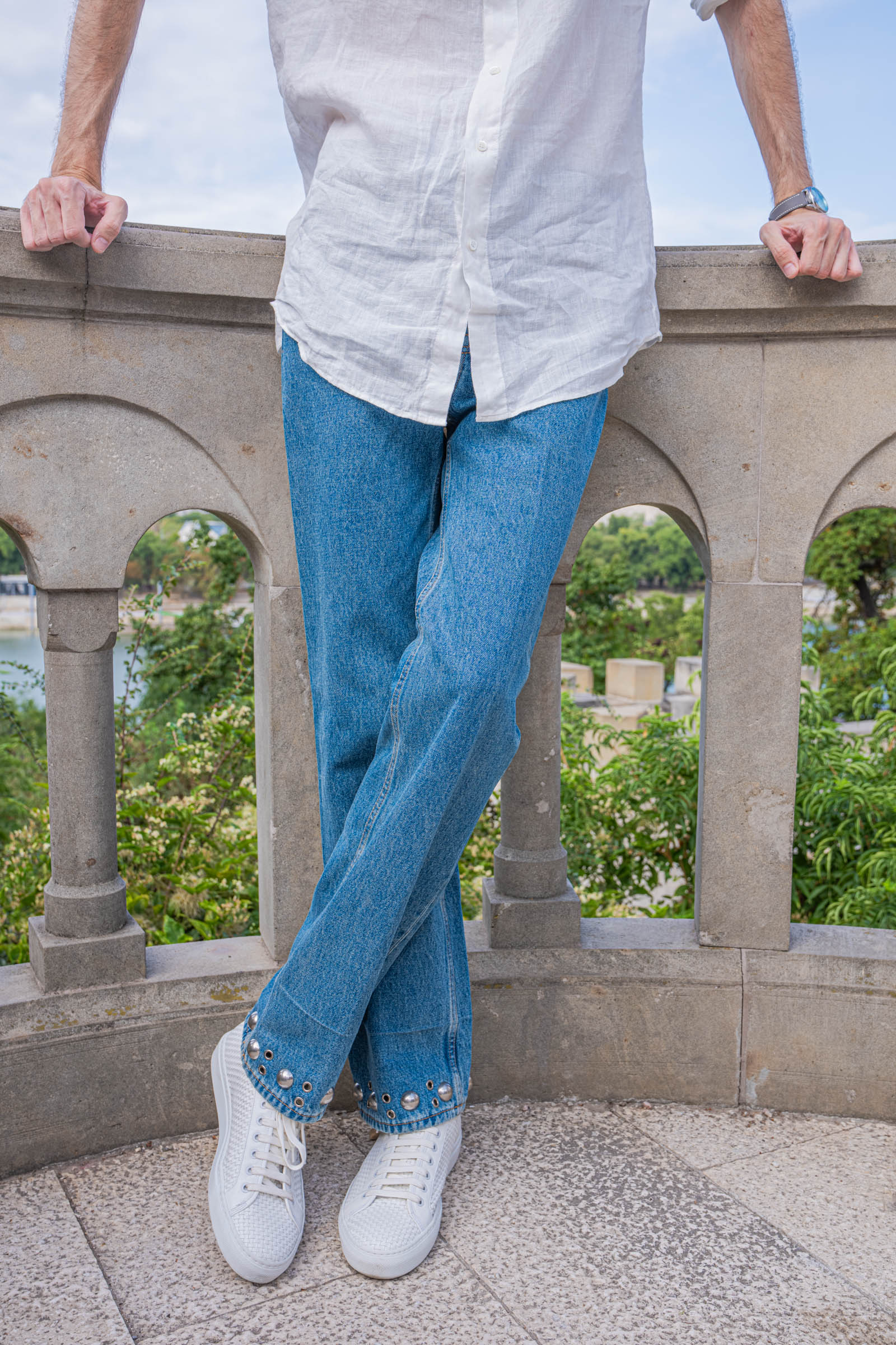 Valentino jeans with studs and eyelets and white woven sneakers on Marko Tadić