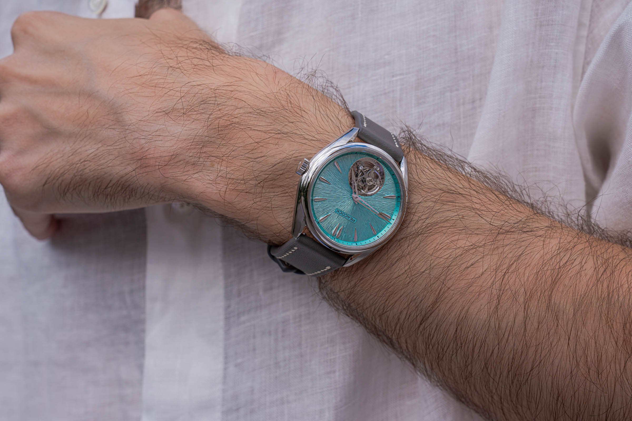 Marko Tadić in an oversized Valentino white linen shirt with Peacock tourbillon on wrist